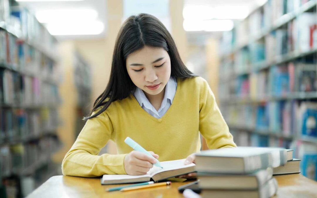 A high school student employing study hacks in the school library.